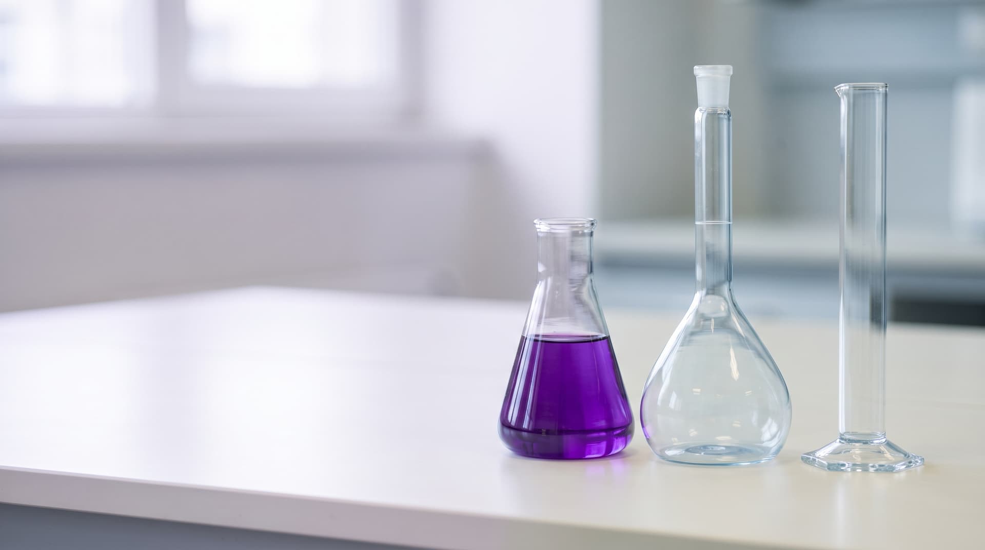 Laboratory glassware arranged on a clean bench in soft daylight